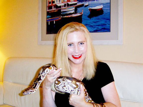Taryn Hook with Larry, a beloved boa constrictor whose affliction prompted the lifelong keeper of reptiles to get in touch with a researcher who hunts down viruses. Credit: Larry Taormina, Ph.D